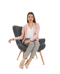 Photo of Young woman sitting in armchair on white background