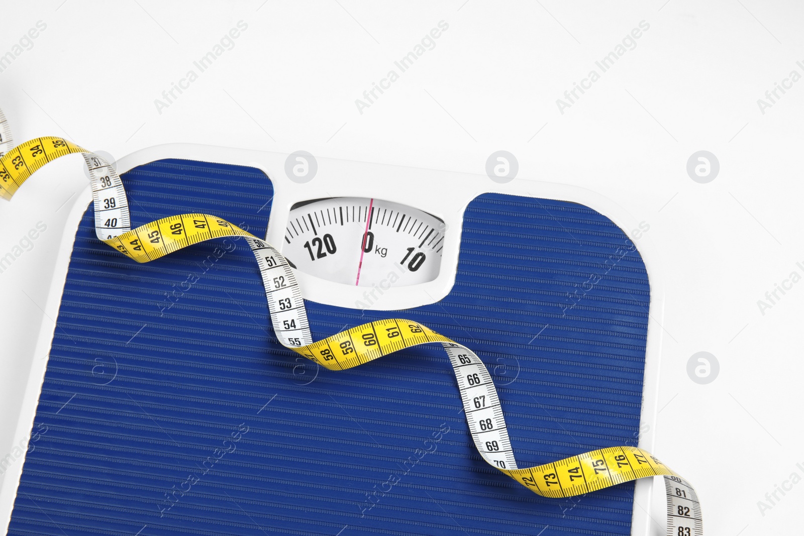 Photo of Modern scales and tape measure isolated on white