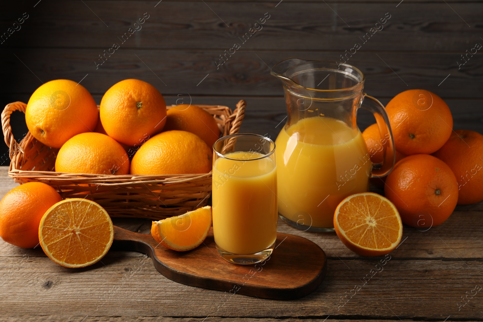 Photo of Tasty fresh oranges and juice on wooden table