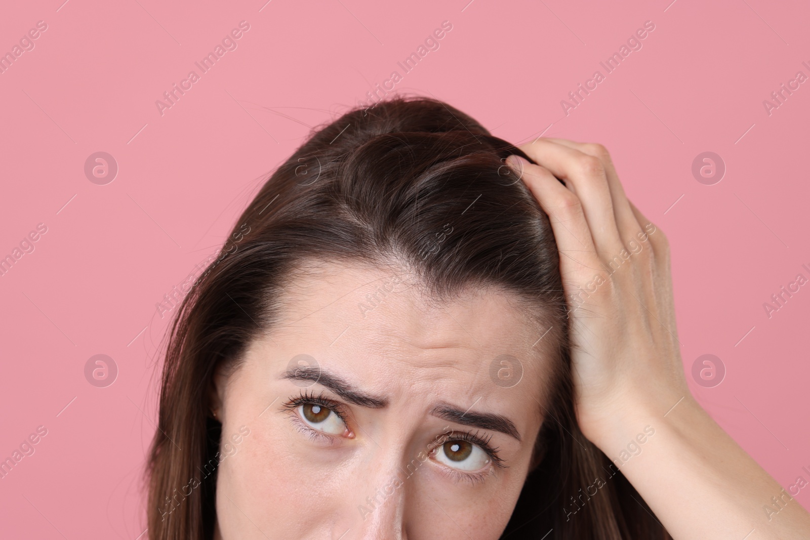 Photo of Sad woman with hair loss problem on pink background, closeup