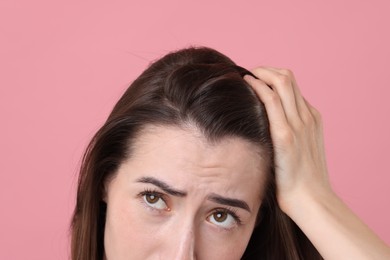 Photo of Sad woman with hair loss problem on pink background, closeup