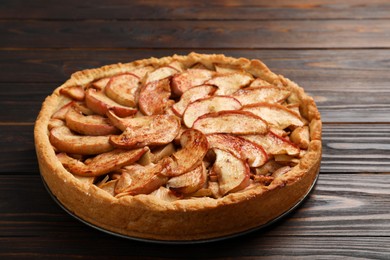 Photo of Fresh delicious apple pie on wooden table