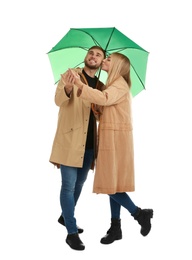 Full length portrait of beautiful couple with umbrella, isolated on white