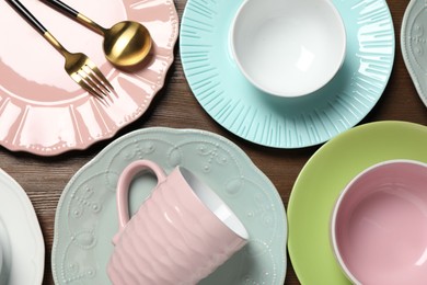 Photo of Beautiful ceramic dishware, cup and cutlery on wooden table, flat lay