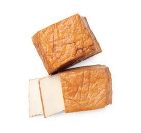 Photo of Cut smoked tofu cheese on white background, top view