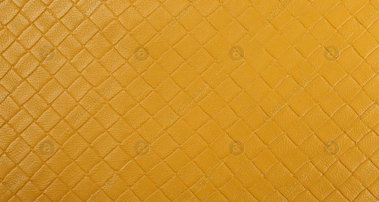 Photo of Beautiful yellow leather as background, top view