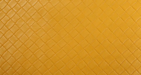 Photo of Beautiful yellow leather as background, top view