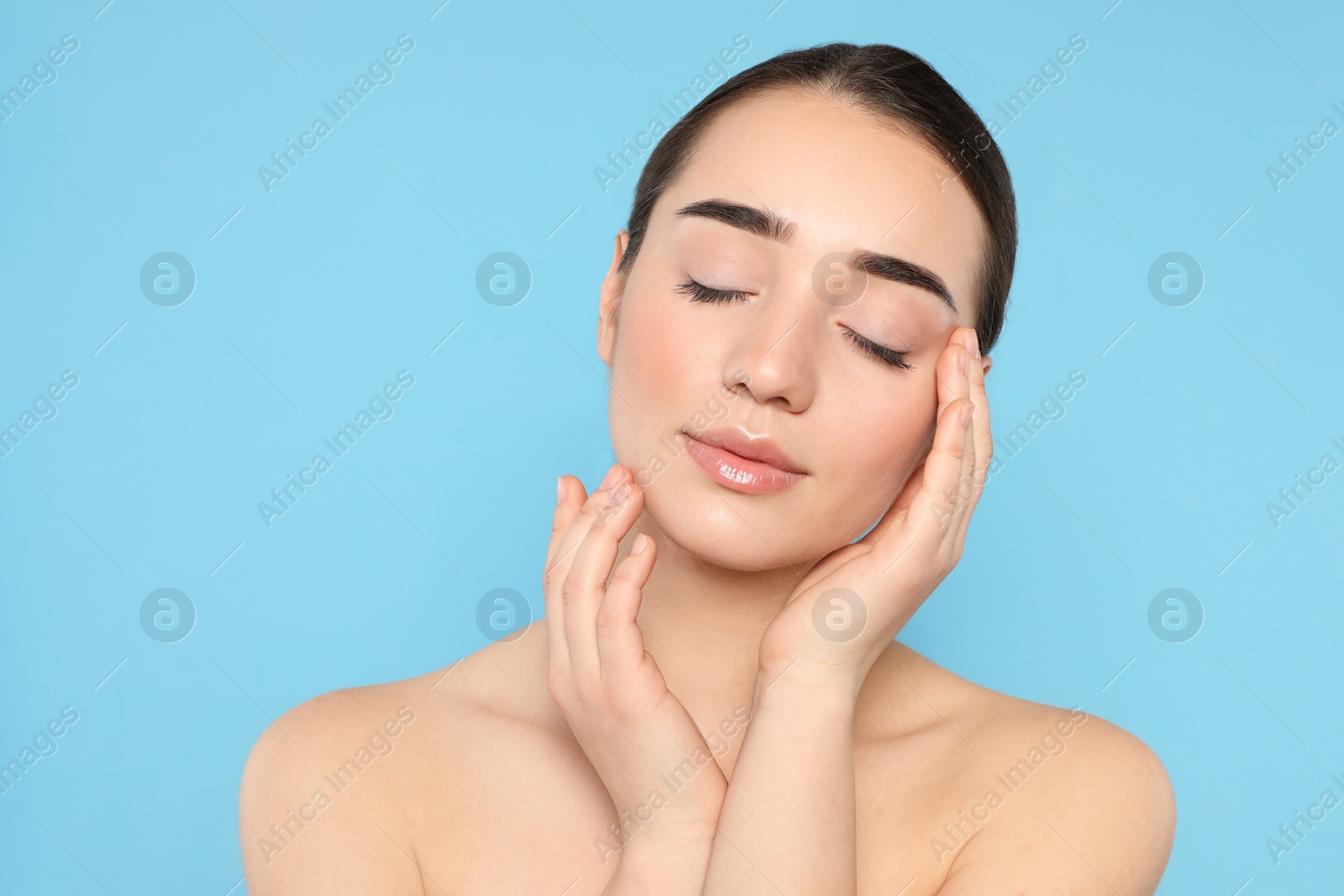 Photo of Portrait of young woman with beautiful face against color background