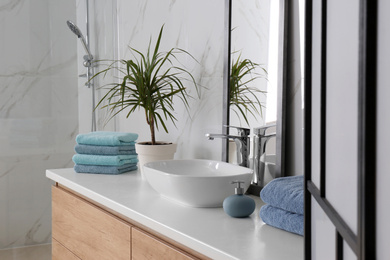 Modern mirror and vessel sink in stylish bathroom