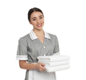 Photo of Portrait of young chambermaid with towels on white background