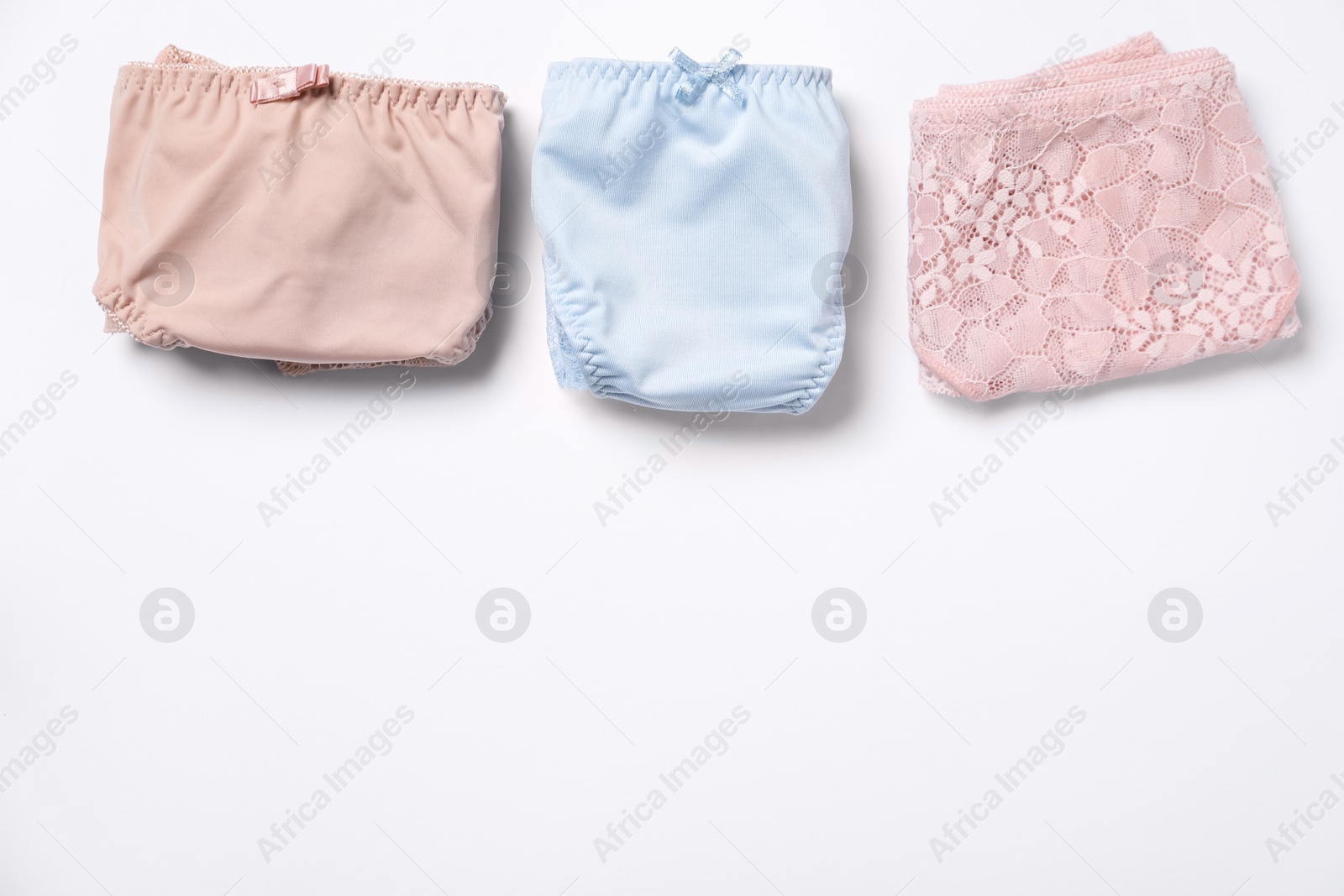 Photo of Stylish folded women's underwear on white background, flat lay. Space for text