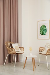 Photo of Living room with pastel window curtain, wooden table and rattan chairs