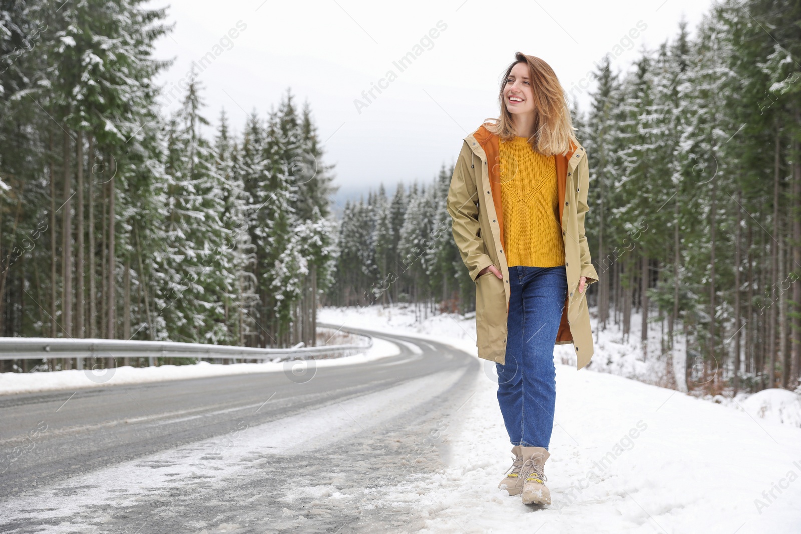 Photo of Young woman walking near snowy forest. Winter vacation