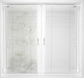 Window with dirty and clean blinds 