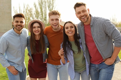 Happy people walking outdoors on sunny day