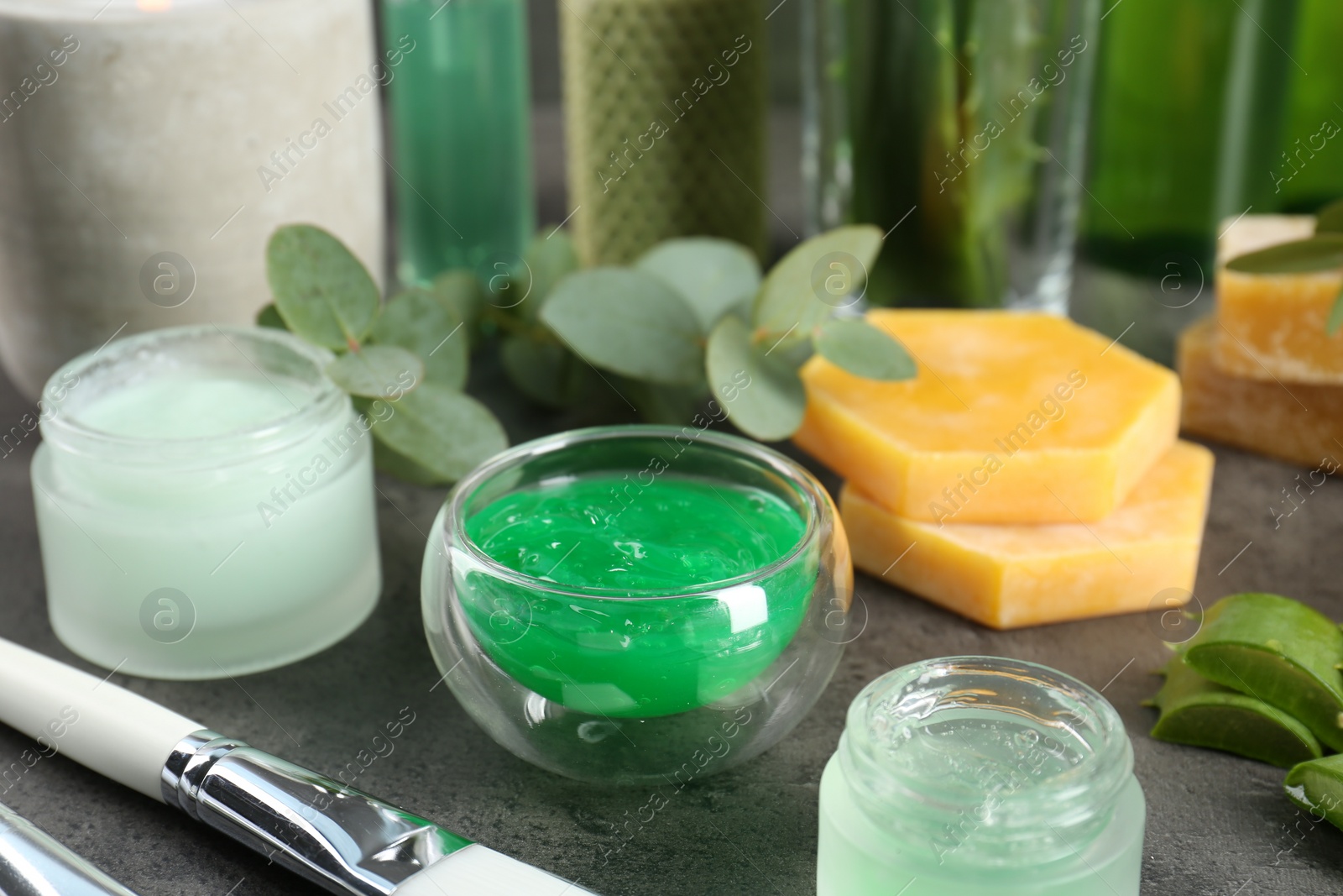 Photo of Homemade cosmetic products and fresh ingredients on black table