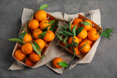 Flat lay composition with fresh ripe tangerines on grey background