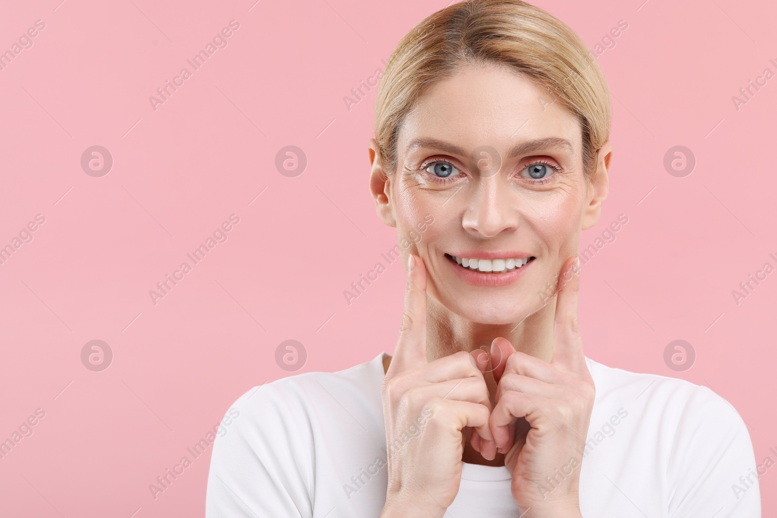 Photo of Woman with clean teeth smiling on pink background, space for text