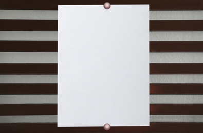 Blank poster attached to striped wall. Space for design