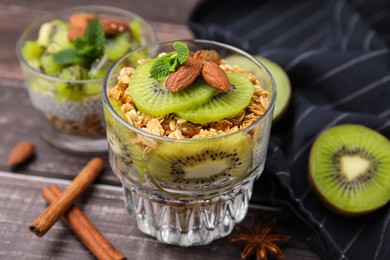 Delicious dessert with kiwi muesli and almonds on wooden table, closeup