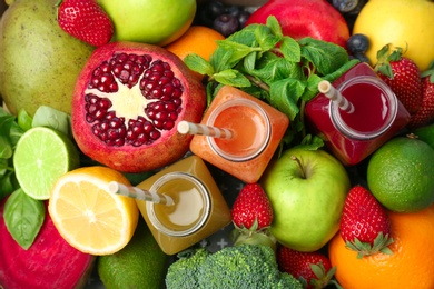 Photo of Bottles with healthy detox smoothies and ingredients as background