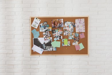 Photo of Vision board with different photos representing dreams on white brick wall