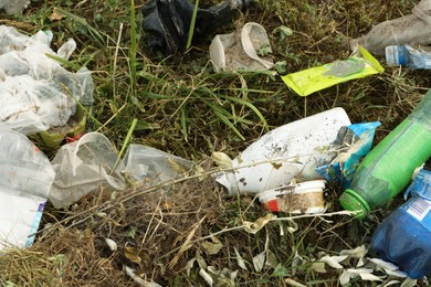 Photo of Garbage scattered on grass. Environment pollution problem