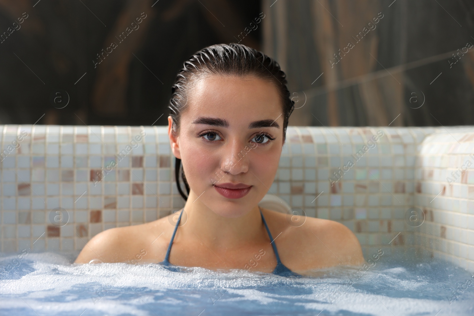 Photo of Beautiful woman relaxing in spa swimming pool