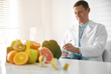 Nutritionist working at desk in his office