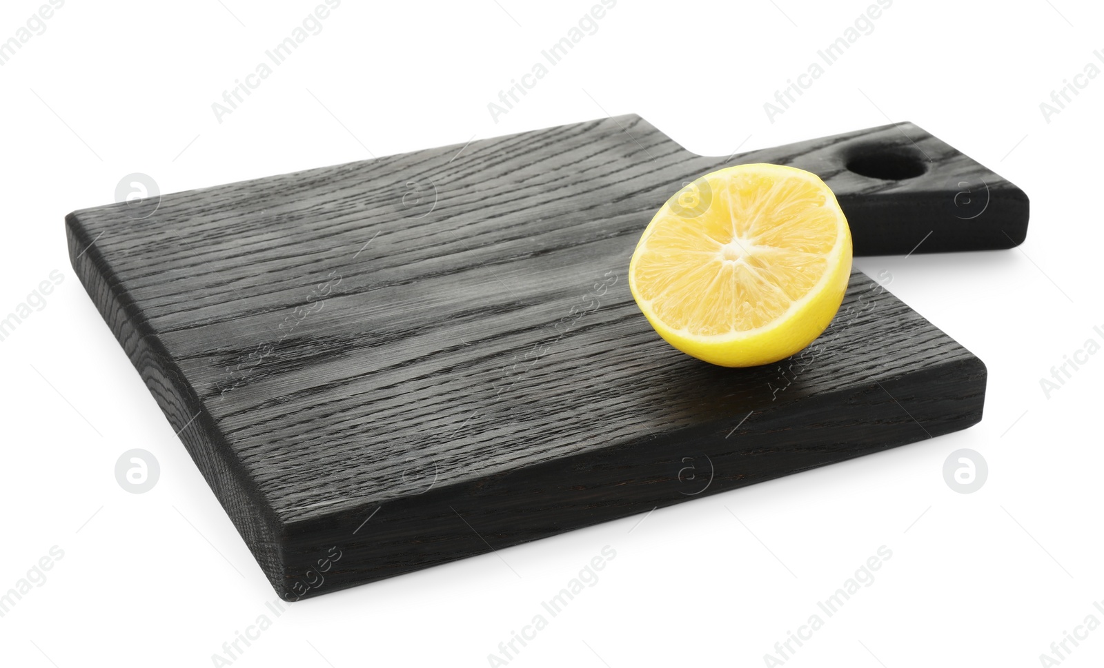 Photo of Wooden cutting board with half of lemon isolated on white