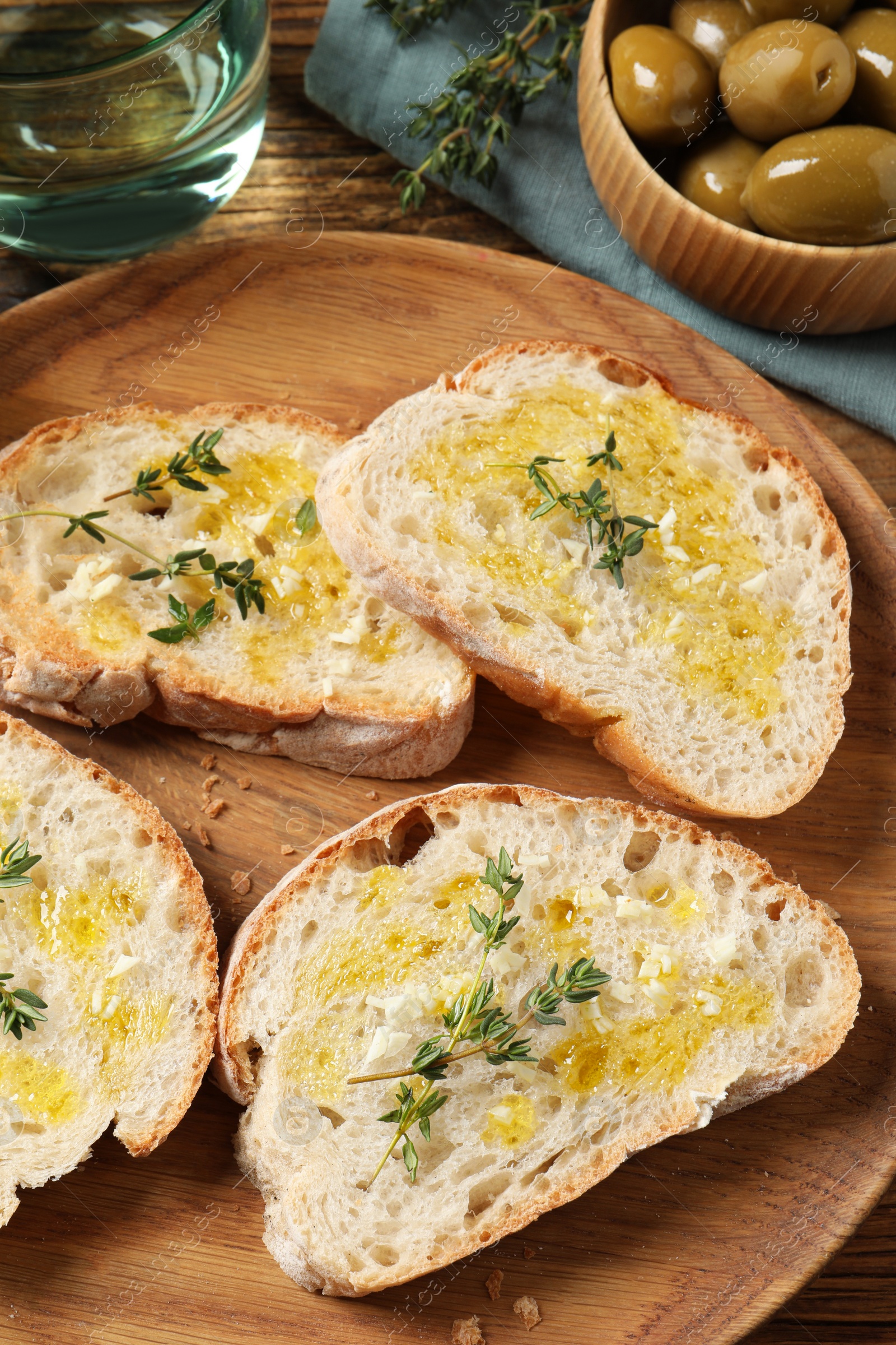 Photo of Tasty bruschettas with oil and thyme on table, above view