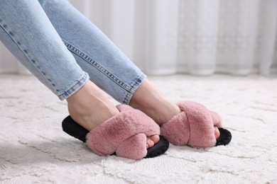 Photo of Woman in soft slippers at home, closeup