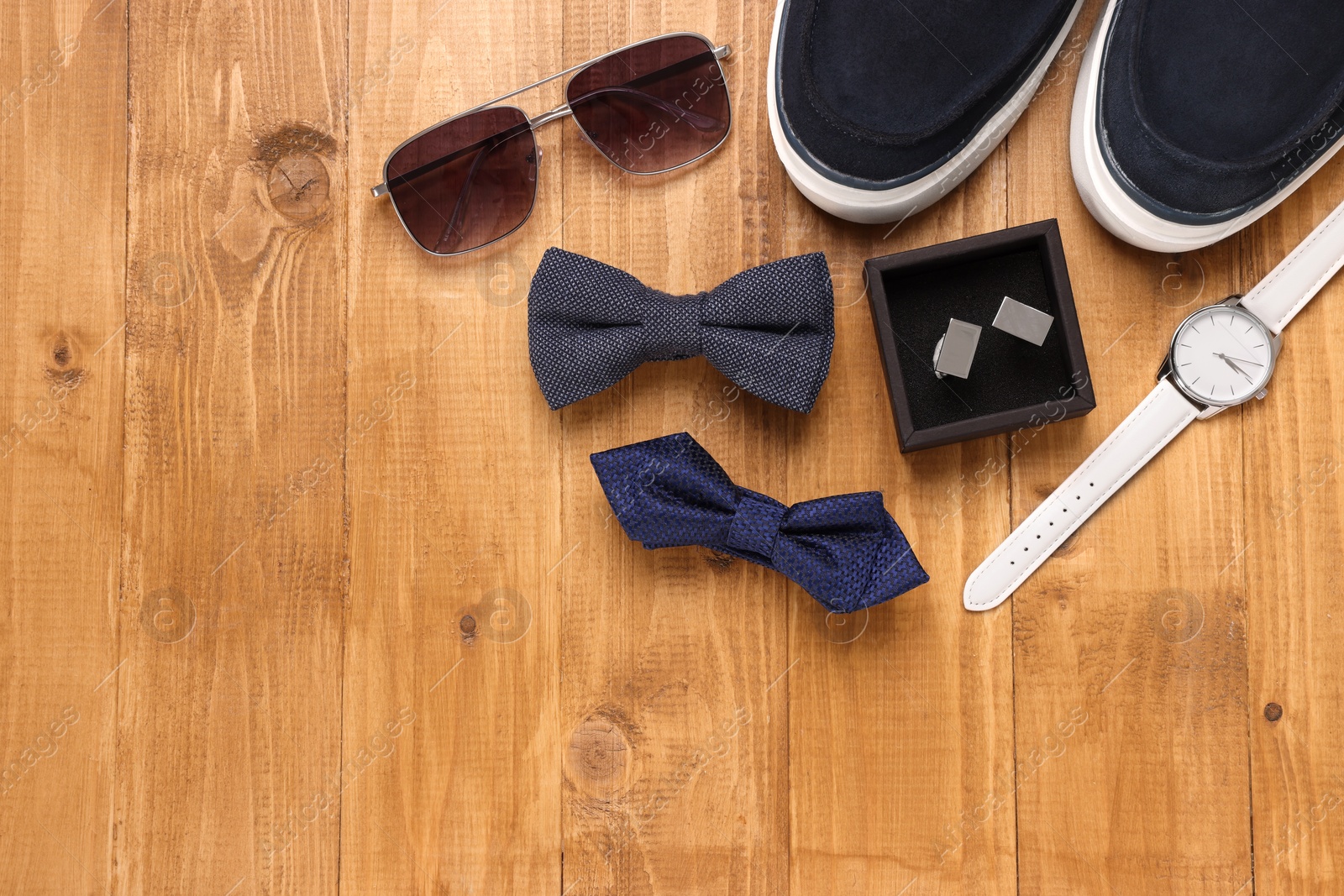 Photo of Flat lay composition with stylish color bow ties on wooden background. Space for text