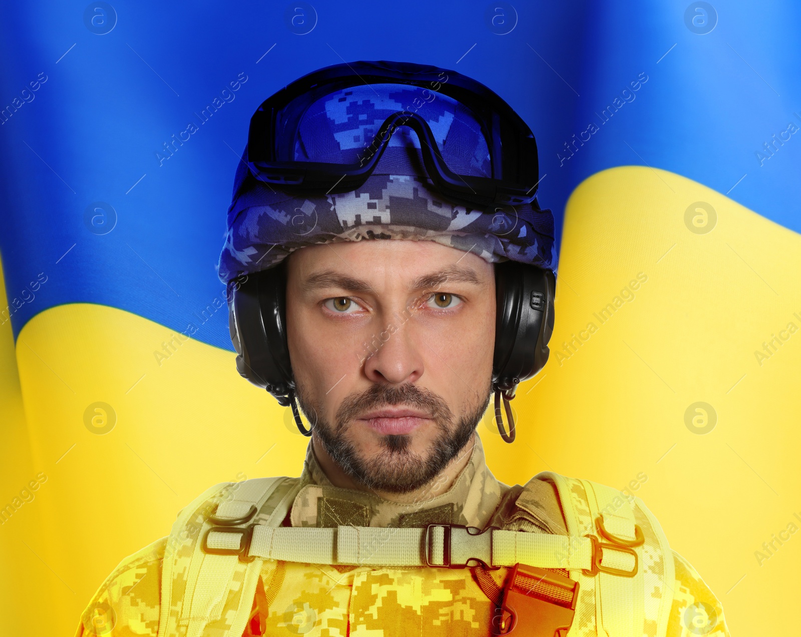 Image of Soldier in military uniform and Ukrainian flag on background