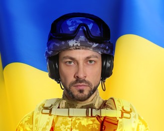 Image of Soldier in military uniform and Ukrainian flag on background