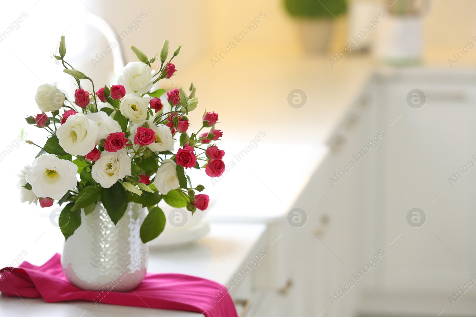 Photo of Vase with fresh flowers on table in kitchen. Space for text