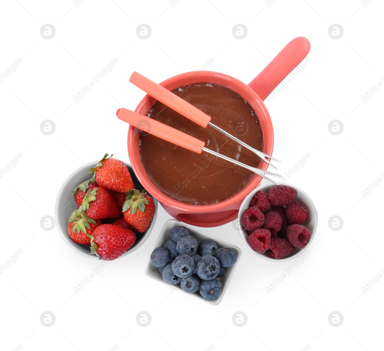 Photo of Fondue pot with melted chocolate, fresh berries and forks isolated on white, top view