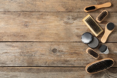Photo of Flat lay composition with shoe care accessories on wooden background, space for text