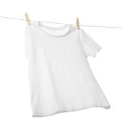 Photo of One t-shirt drying on washing line isolated on white, low angle view