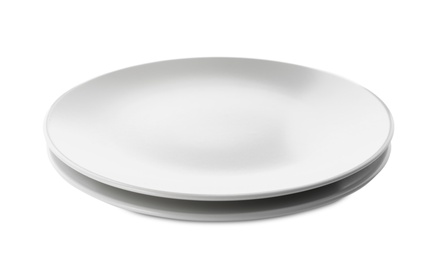 Photo of Clean empty ceramic plates on white background