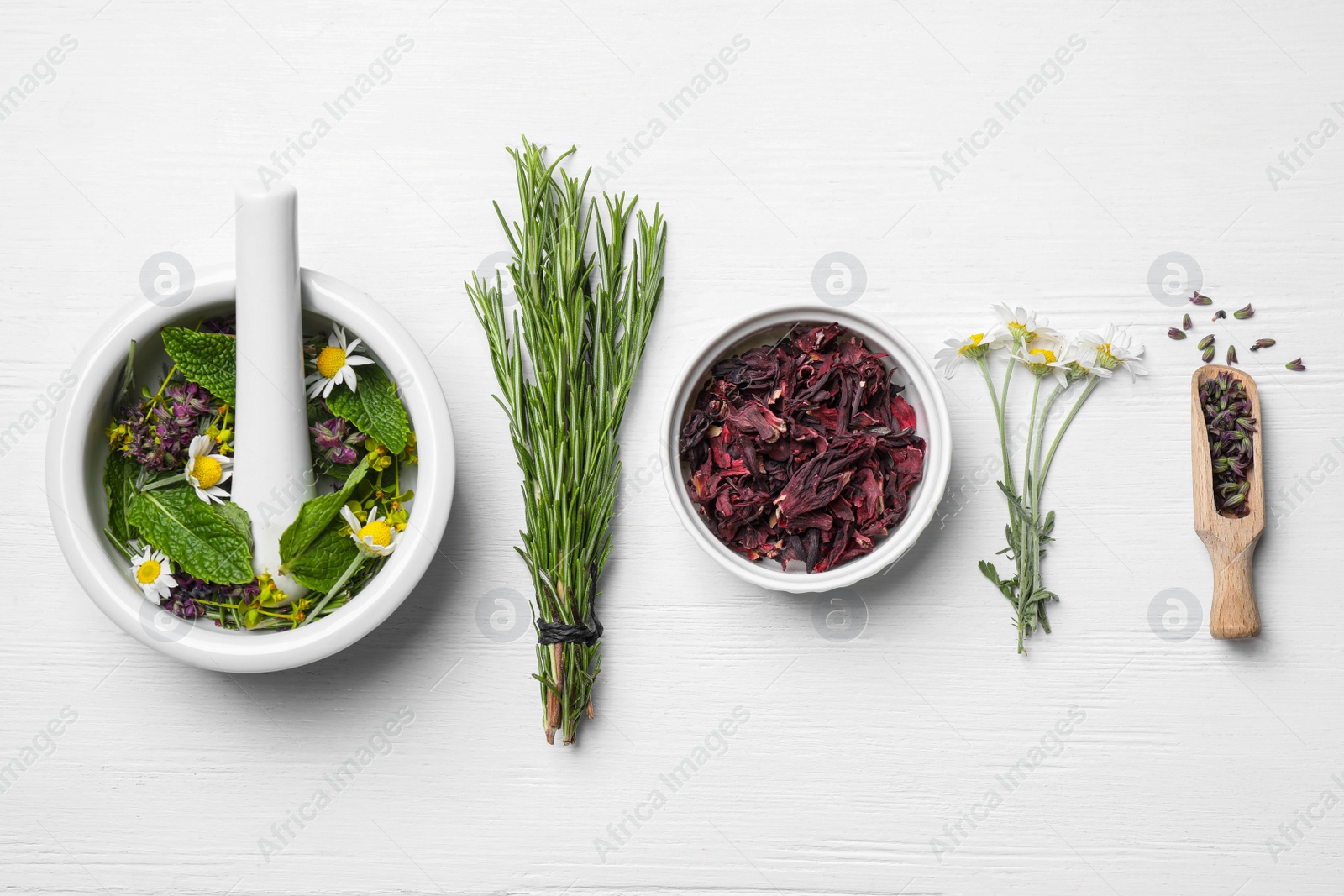 Photo of Flat lay composition with healing herbs on white wooden table