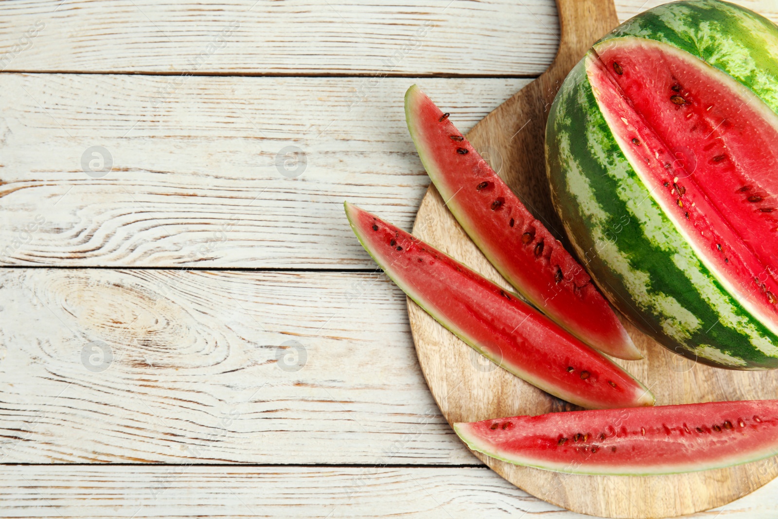 Photo of Yummy watermelon on white wooden table, top view. Space for text