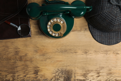 Photo of Flat lay composition with vintage detective items on wooden background, space for text