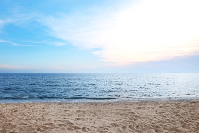 Picturesque landscape with calm sea and beach under blue sky