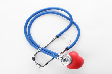 Stethoscope and red heart on white background, top view