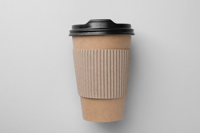 Photo of One paper cup on light grey background, top view. Coffee to go