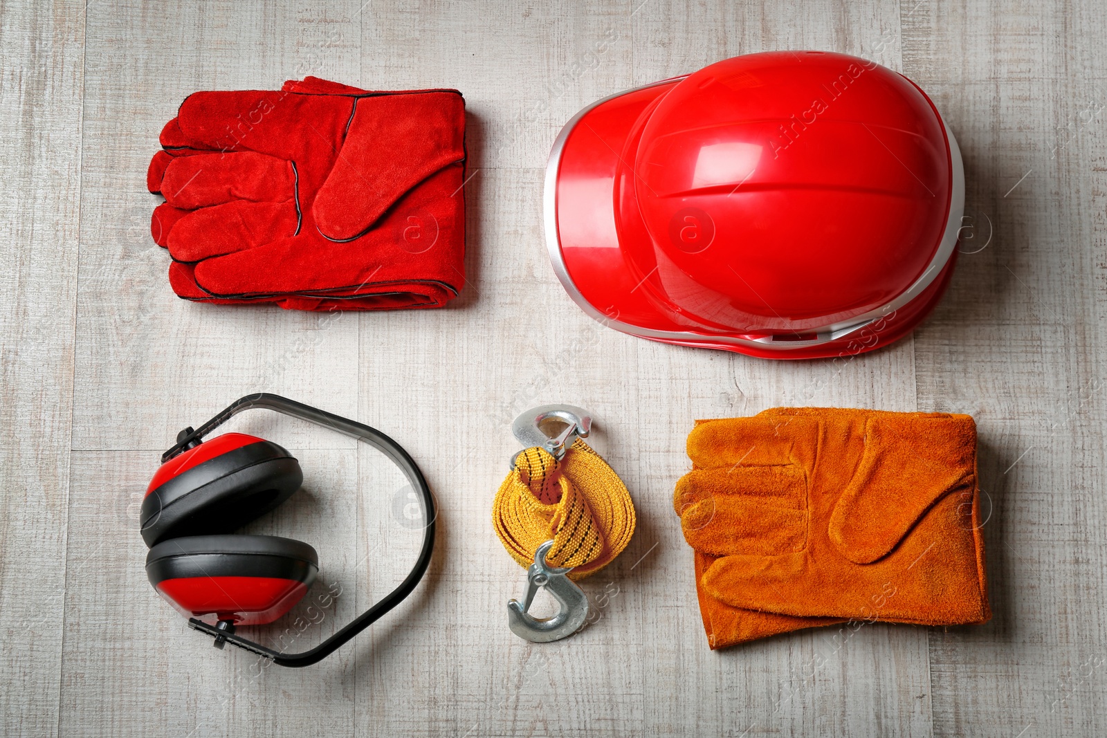 Photo of Flat lay composition with safety equipment on wooden background