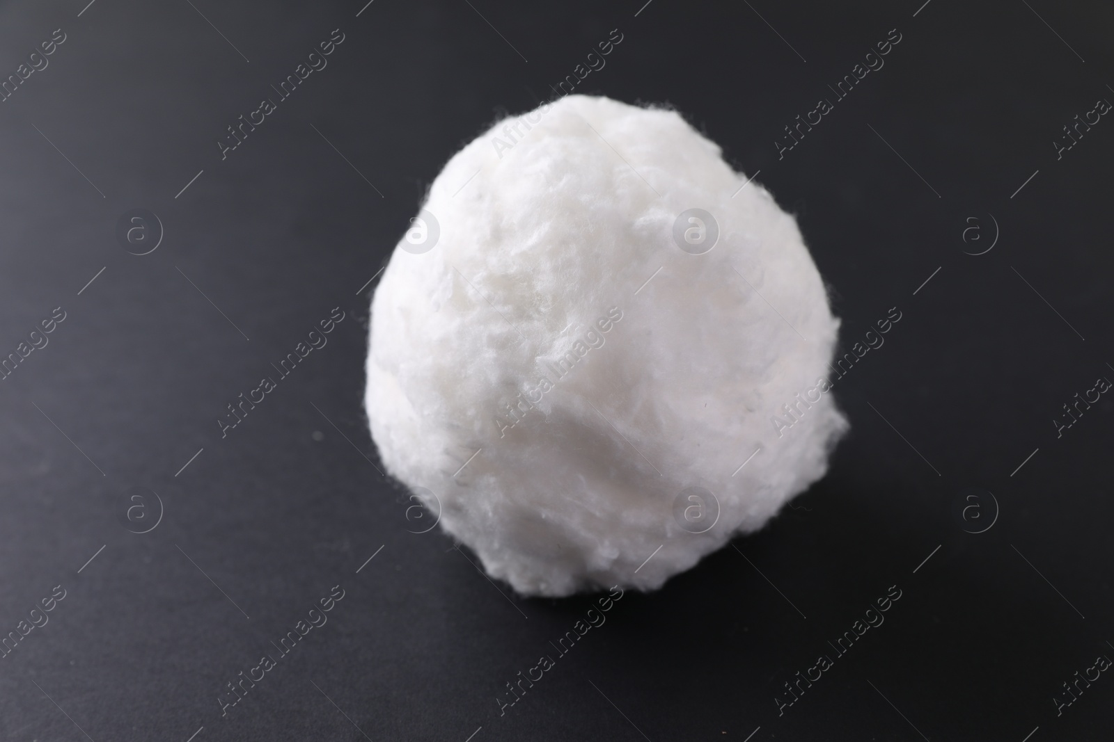 Photo of Ball of clean cotton wool on grey background, closeup