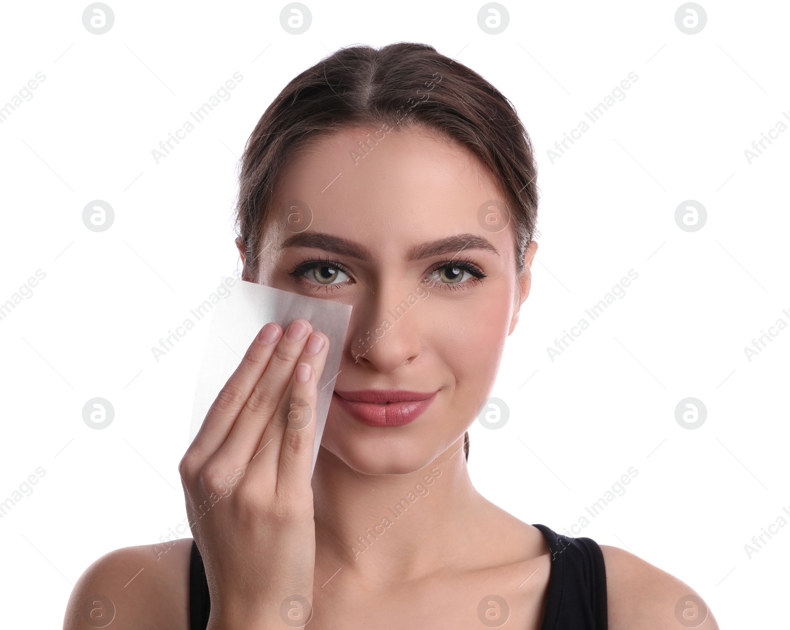 Photo of Beautiful woman using mattifying wipe on white background