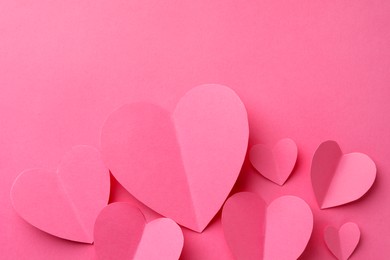 Paper hearts on pink background, flat lay. Space for text